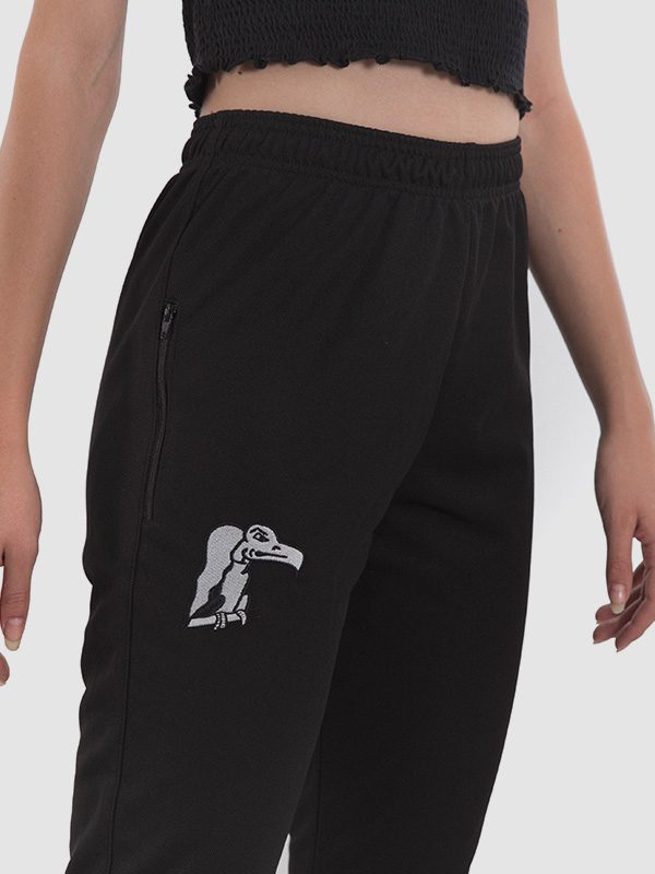 Black football training pants women. White logo of a bird printed on the right thigh.
