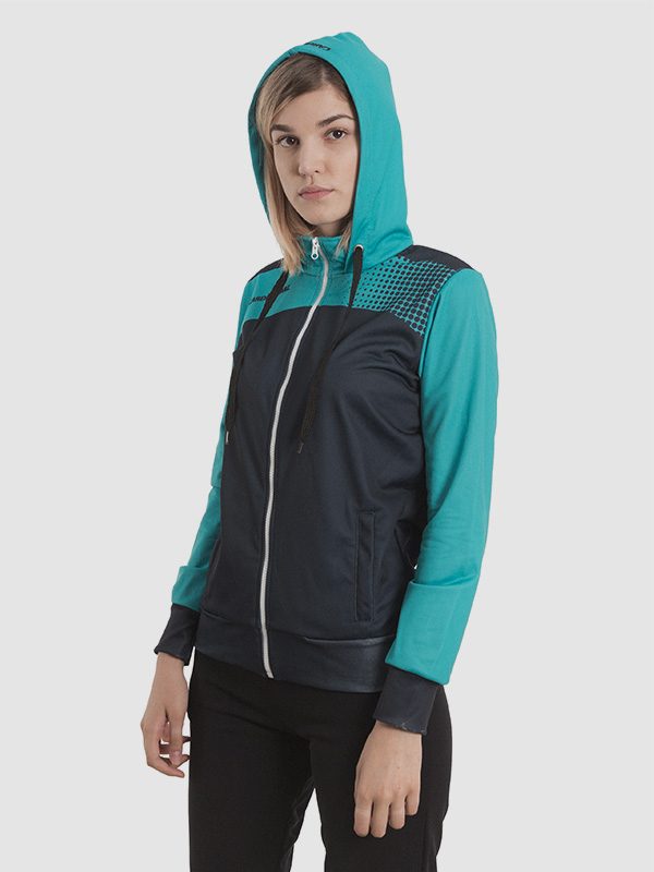 A female model wearing a hooded cyan and black tracksuit.